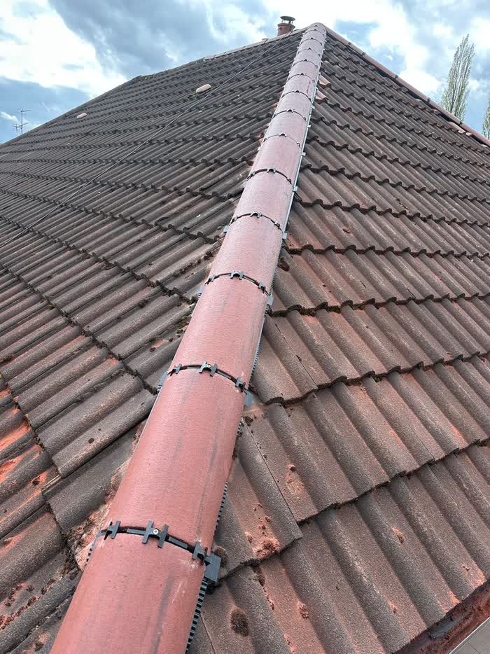 Tiled roof with ridge tiles refitted along the full run